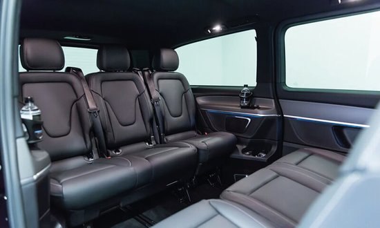 Black leather rear cabin with the bench seat and sliding door open